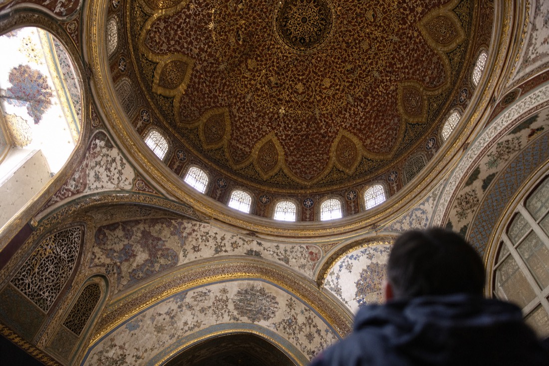 Ornate domed ceiling of a Topkapi Palace Harem chamber with painted and gilded decoration