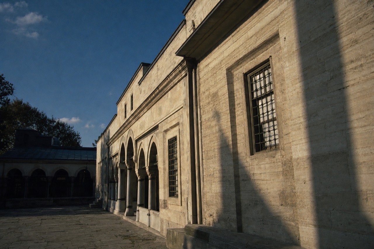 Stone facade and barred windows of the Imperial Treasury building in a Topkapi Palace courtyard