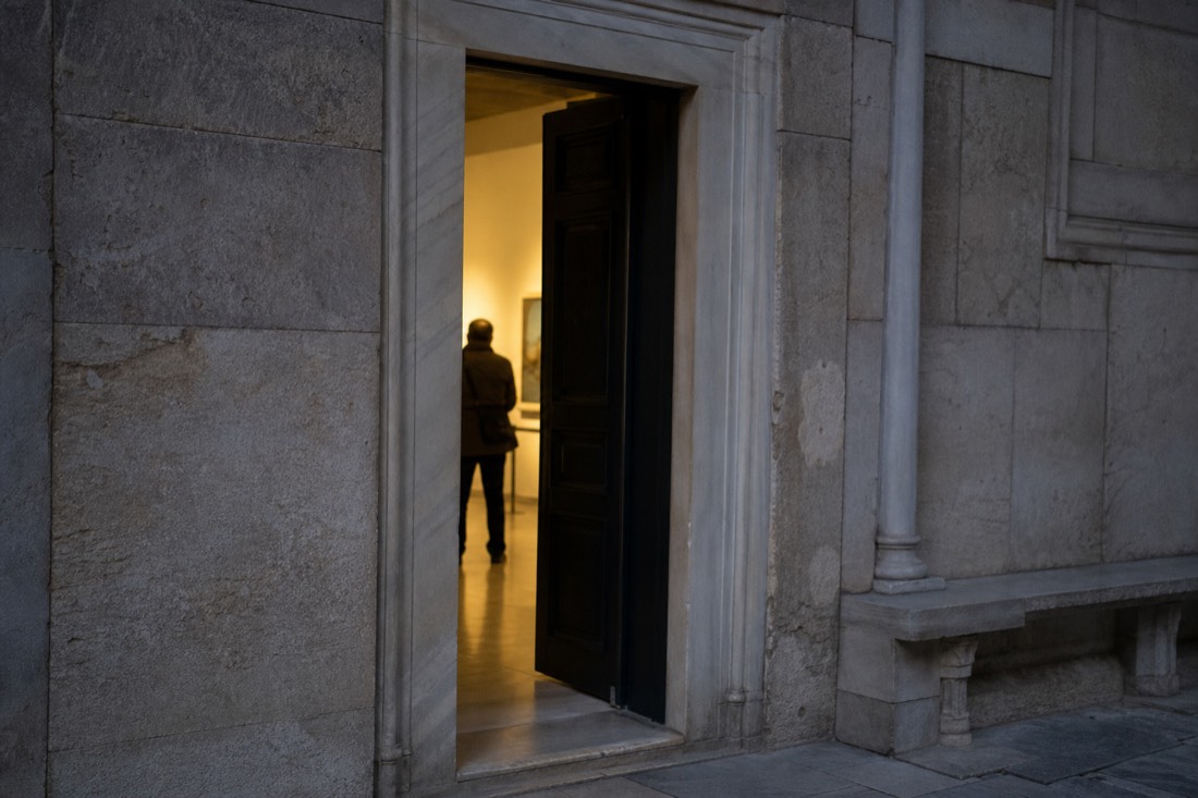 Stone doorway of a Topkapi Palace gallery with a soft interior glow beyond
