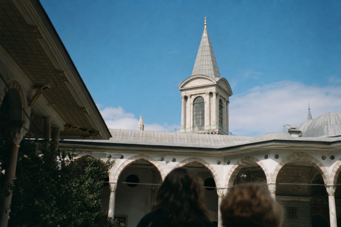 The Tower of Justice rising above the second courtyard of Topkapı Palace against a clear sky
