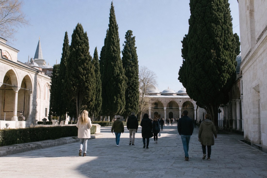Visitors in a courtyard of Topkapi Palace exploring at their own pace with a skip-the-line audio-guide ticket